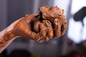 Image showing hands of a potter with clay, closeup