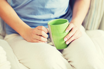 Image showing close up of young woman with tea cup