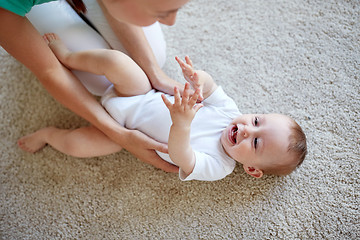 Image showing happy mother playing with baby at home