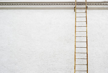 Image showing White stucco wall with metal ladder