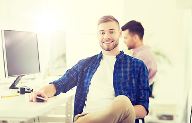 Image showing happy creative man with cellphone at office