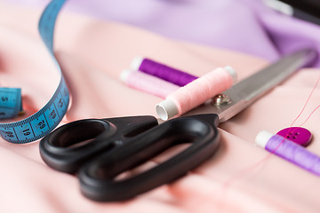 Image showing scissors, sewing buttons, threads and tape measure