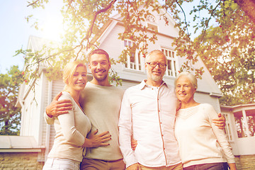 Image showing happy family in front of house outdoors