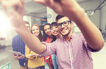 Image showing creative business team taking selfie at office