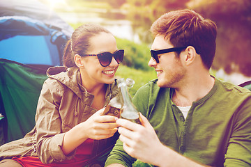 Image showing happy couple clinking drinks at campsite tent