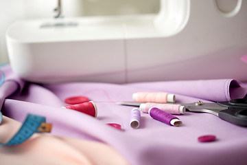 Image showing sewing machine, scissors, buttons and fabric