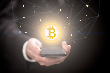 Image showing Businessman with bitcoin sign , smartphone