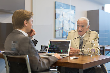 Image showing Financial advisor consulting senior client with his investment strategy.