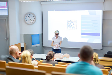 Image showing Instructor teaching first aid cardiopulmonary resuscitation workshop.