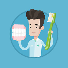 Image showing Dentist with dental jaw model and toothbrush.