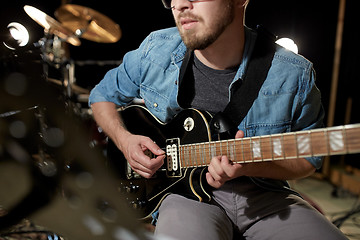 Image showing man playing guitar at studio rehearsal