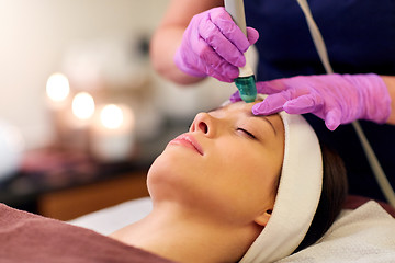 Image showing woman having microdermabrasion facial treatment