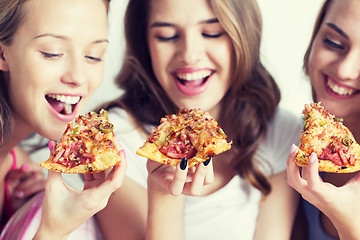 Image showing happy friends or teen girls eating pizza at home