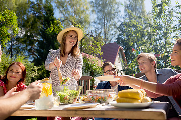 Image showing happy friends having dinner at summer garden party