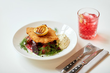 Image showing close up of fish salad with roasted lemon on plate