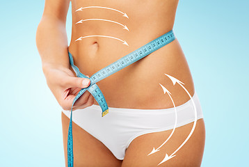 Image showing close up of woman body with measure tape on waist