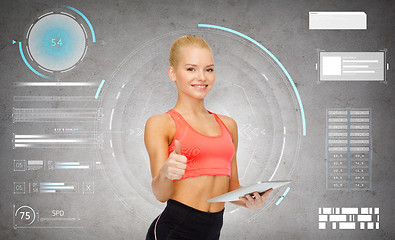 Image showing sporty woman with tablet pc showing thumbs up