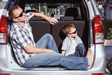 Image showing Happy father and son getting ready for road trip on a sunny day