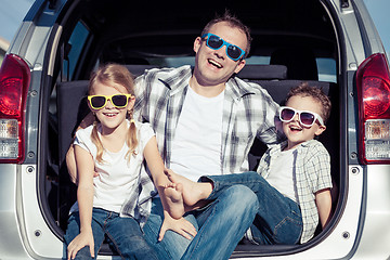 Image showing Happy family getting ready for road trip on a sunny day