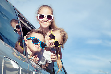 Image showing Happy children getting ready for road trip on a sunny day