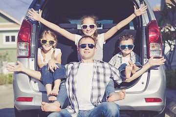 Image showing Happy family getting ready for road trip on a sunny day