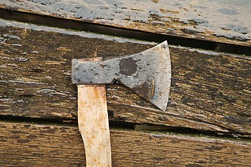 Image showing Axe on wet planks