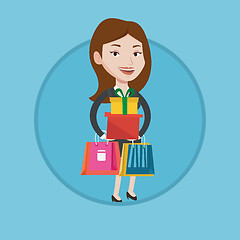 Image showing Happy woman holding shopping bags and gift boxes.