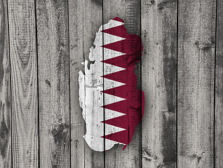 Image showing Map and flag of Qatar on weathered wood