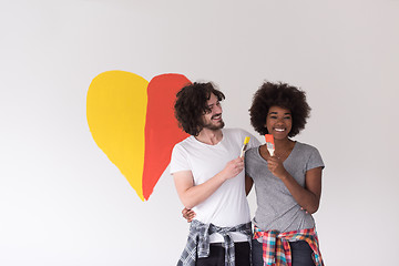 Image showing couple with painted heart on wall