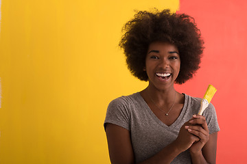 Image showing black woman painting wall