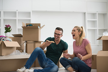 Image showing young couple have a pizza lunch break on the floor