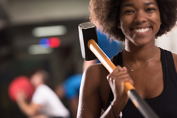 Image showing black woman after workout with hammer