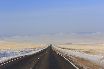 Image showing Winter road leaving into distance into the mountains
