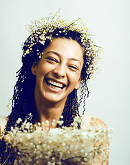 Image showing young pretty brunette girl with bouquet of little white spring f