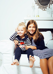 Image showing two cute sisters at home interior playing, little happy smiling 