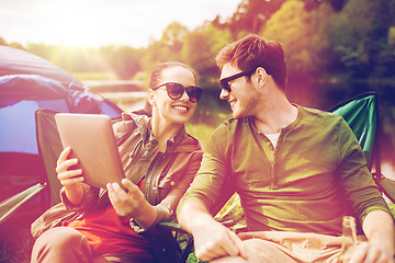Image showing happy couple with tablet pc at camping tent