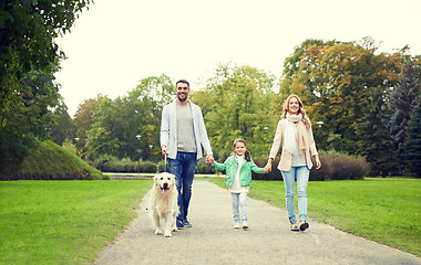 Image showing happy family with labrador retriever dog in park