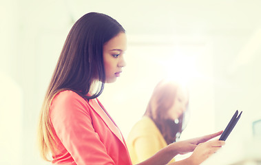 Image showing creative african woman with tablet pc at office