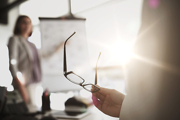 Image showing businessman with glasses at presentation in office