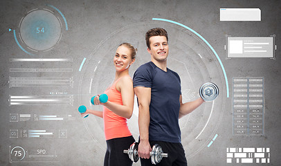 Image showing sportive man and woman with dumbbells