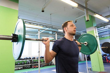 Image showing man doing exercise with barbell in gym