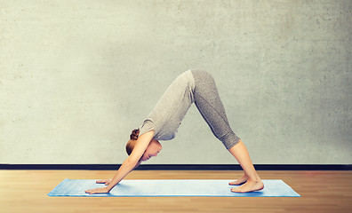 Image showing woman making yoga dog pose on mat