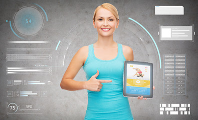 Image showing sporty woman with fitness application on tablet pc