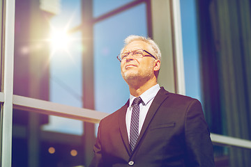 Image showing senior businessman on city street