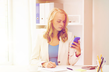 Image showing businesswoman texting on smartphone at office