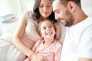 Image showing happy family in bed at home