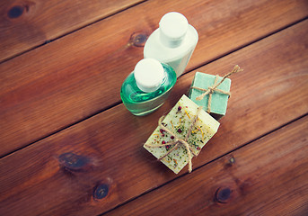 Image showing close up of handmade soap bars and lotions on wood