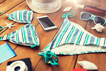 Image showing close up of smartphone and beach stuff