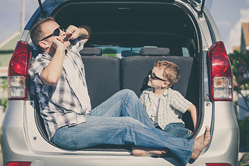 Image showing Happy father and son getting ready for road trip on a sunny day