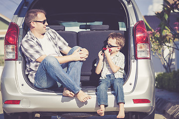 Image showing Happy father and son getting ready for road trip on a sunny day